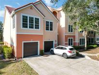 Two-story condo building with attached garage and driveway at 4106 Central Sarasota Pkwy # 1013, Sarasota, FL 34238