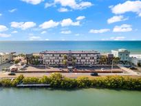 Oceanfront building aerial view, showing parking and beachfront location at 60 Gulf Blvd # 402, Indian Rocks Beach, FL 33785