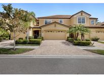 Attractive townhome with a two-car garage and landscaped front yard at 8141 Miramar Way # 8141, Lakewood Ranch, FL 34202