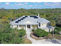 Large home with solar panels and a waterfront lot at 4678 Silent Creek Way, Nokomis, FL 34275