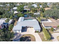 Aerial view of waterfront home with pool and private dock at 5072 Higel Ave, Sarasota, FL 34242