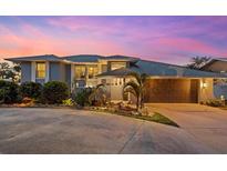 Stunning waterfront home with a modern design, beautifully landscaped yard, and a charming curb appeal at 609 Elba Dr, Nokomis, FL 34275