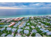 Aerial view of beach town home with private parking and lush landscaping at 6250 Holmes Blvd # 32, Holmes Beach, FL 34217