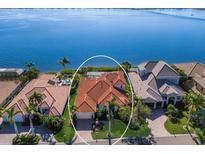 Luxury waterfront home with private pool and lush landscaping at 805 Riviera Dunes Way, Palmetto, FL 34221
