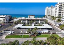 Beautiful beachfront condominium with covered parking, tropical landscaping, and clear blue skies at 2110 Benjamin Franklin Dr # 105, Sarasota, FL 34236