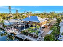 Waterfront home featuring a boat lift, dock, upper deck and pool at 521 Cummings St, Sarasota, FL 34242