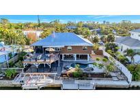 Waterfront home featuring a deck, outdoor bar, and pool, perfect for entertaining and enjoying the Florida lifestyle at 521 Cummings St, Sarasota, FL 34242