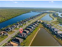 Aerial view of a waterfront community with luxury homes and lush landscaping at 15145 Spanish Point Dr, Port Charlotte, FL 33981