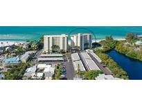 Beautiful aerial view of two condominium buildings and a white sand beach on the Gulf of Mexico at 19 Whispering Sands Dr # 301, Sarasota, FL 34242