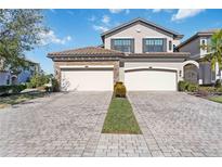 Two-story home with three-car garage and paver driveway at 5830 Wake Forest Run # 102, Bradenton, FL 34211