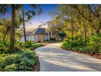 Luxury home with circular driveway, lush landscaping, and a private setting at 6700 S Gator Creek Blvd, Sarasota, FL 34241