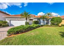 Beautiful one-story home with a two-car garage and lush landscaping at 6847 Bay Hill Dr, Lakewood Ranch, FL 34202