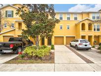Two-story townhome with two-car garage and landscaped front yard at 7325 Black Walnut Way, Lakewood Ranch, FL 34202