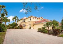 Beautiful two-story home with a tile roof, brick driveway, and meticulously landscaped grounds at 9623 Sea Turtle Ter # 201, Bradenton, FL 34212