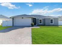 One-story home with a two-car garage and a well-manicured lawn at 1016 42Nd E Ter, Bradenton, FL 34208