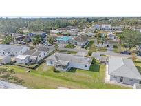 Aerial view of a single-Gathering home with a large backyard and surrounding neighborhood at 1521 Graber Ave, Sarasota, FL 34239