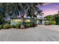 Charming mid-century home with landscaped yard and paver driveway at 312 Hardin Ave, Anna Maria, FL 34216