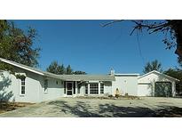 Ranch-style home with attached two-car garage and large driveway at 4712 Seville Dr, Sarasota, FL 34235