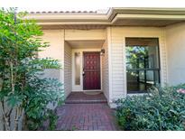Inviting front door entrance with brick walkway at 4802 Kestral Park Cir # 22, Sarasota, FL 34231