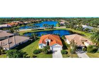 Aerial view of a beautiful home community with a lake at 4867 Sabal Lake Cir, Sarasota, FL 34238