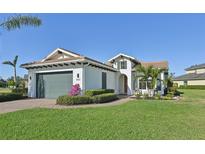 Single-story house with a two-car garage and well-manicured lawn at 5060 Lake Overlook Ave, Bradenton, FL 34208