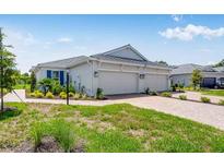 Charming home featuring a paved driveway, lush landscaping and a three-car garage for ample parking at 6107 Mesa Gln, Bradenton, FL 34203
