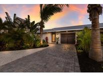 Attractive home exterior with a paved driveway and lush landscaping at 213 83Rd St # East, Holmes Beach, FL 34217