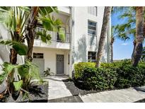Inviting condo entry with a well-maintained walkway and landscaping at 4330 Falmouth Dr # 108, Longboat Key, FL 34228