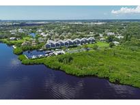 Aerial view of waterfront community with tennis court and boat slips at 515 Leffingwell Ave # 109, Ellenton, FL 34222