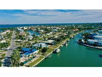Beautiful aerial view of a waterfront community with canals leading to the bay at 6011 Emerald Harbor Dr, Longboat Key, FL 34228