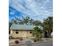 Tan house with palm trees and a gravel driveway at 4706 3Rd W Ave, Bradenton, FL 34209