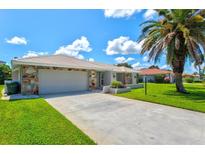 Charming single-story home features a stone facade, tile roof, and a well-maintained lawn at 482 Rubens Dr E, Nokomis, FL 34275