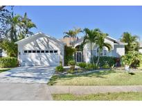 Charming single-story home featuring a well-manicured lawn, a two-car garage, and tropical landscaping at 5307 52Nd W Ave, Bradenton, FL 34210
