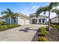 Beautiful single-Gathering home with a paved driveway, well-manicured landscaping, and a two-car garage at 8328 Sea Glass Ct, Sarasota, FL 34240