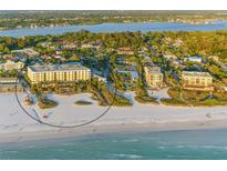 Aerial view of beachfront condo building with ocean and surrounding neighborhood at 915 Seaside Dr # 312 Weeks 16-17, Sarasota, FL 34242