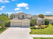 Charming home featuring a three-car garage, tile roof, and well-manicured landscaping at 1743 Pinyon Pine Dr, Sarasota, FL 34240