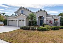 Inviting home features a well-manicured lawn, mature trees and a spacious three-car garage at 1743 Pinyon Pine Dr, Sarasota, FL 34240