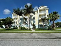 Three-story condo building with palm trees and ample parking at 3404 79Th Street W Cir # 203, Bradenton, FL 34209