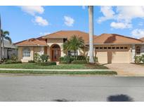 Attractive single-story home with a tile roof, two-car garage, and lush landscaping at 4423 Via Del Villetti Dr, Venice, FL 34293