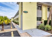 Sea Winds building exterior, unit 6703, showing building features and landscaping at 6703 Midnight Pass Rd # 208, Sarasota, FL 34242