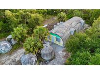 Aerial view of unique property with several dome structures and a long, rectangular building at 5293 Basket St, North Port, FL 34288