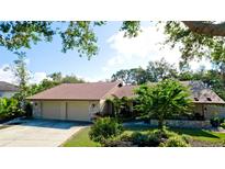 Two-car garage, mature landscaping, and a welcoming curb appeal at 1221 89Th Nw St, Bradenton, FL 34209