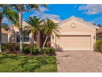 Single-story home with a two-car garage and landscaped front yard at 4311 65Th E Ter, Sarasota, FL 34243