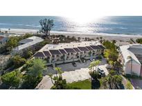 Aerial view of beachfront condos with parking and ocean access at 5635 Gulf Of Mexico Dr # 103, Longboat Key, FL 34228