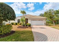 Single-story home with landscaped yard, driveway, and two-car garage at 6504 Copper Ridge Trl, Bradenton, FL 34201