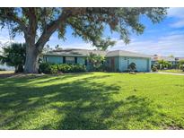 Charming ranch home with lush lawn and mature tree at 907 60Th Nw St, Bradenton, FL 34209