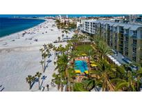 Aerial view of condo building, pool, and beach, showing its prime location at 915 Seaside Dr # 604, Sarasota, FL 34242