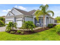 Beautiful single-story home with a two-car garage and lush landscaping at 11877 Hunters Creek Rd, Venice, FL 34293
