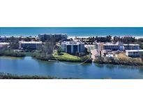 Aerial view of waterfront condo building with tennis courts and pool at 3240 Gulf Of Mexico Dr # B504, Longboat Key, FL 34228