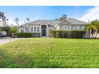 Beautiful one-story home featuring a well-maintained lawn and inviting curb appeal at 4801 Brickell Dr, North Port, FL 34286